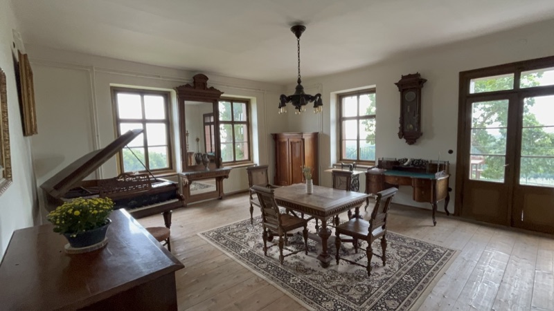 The salon at the Villa, with grand piano and period furniture